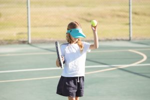 Girl playing tennis at court